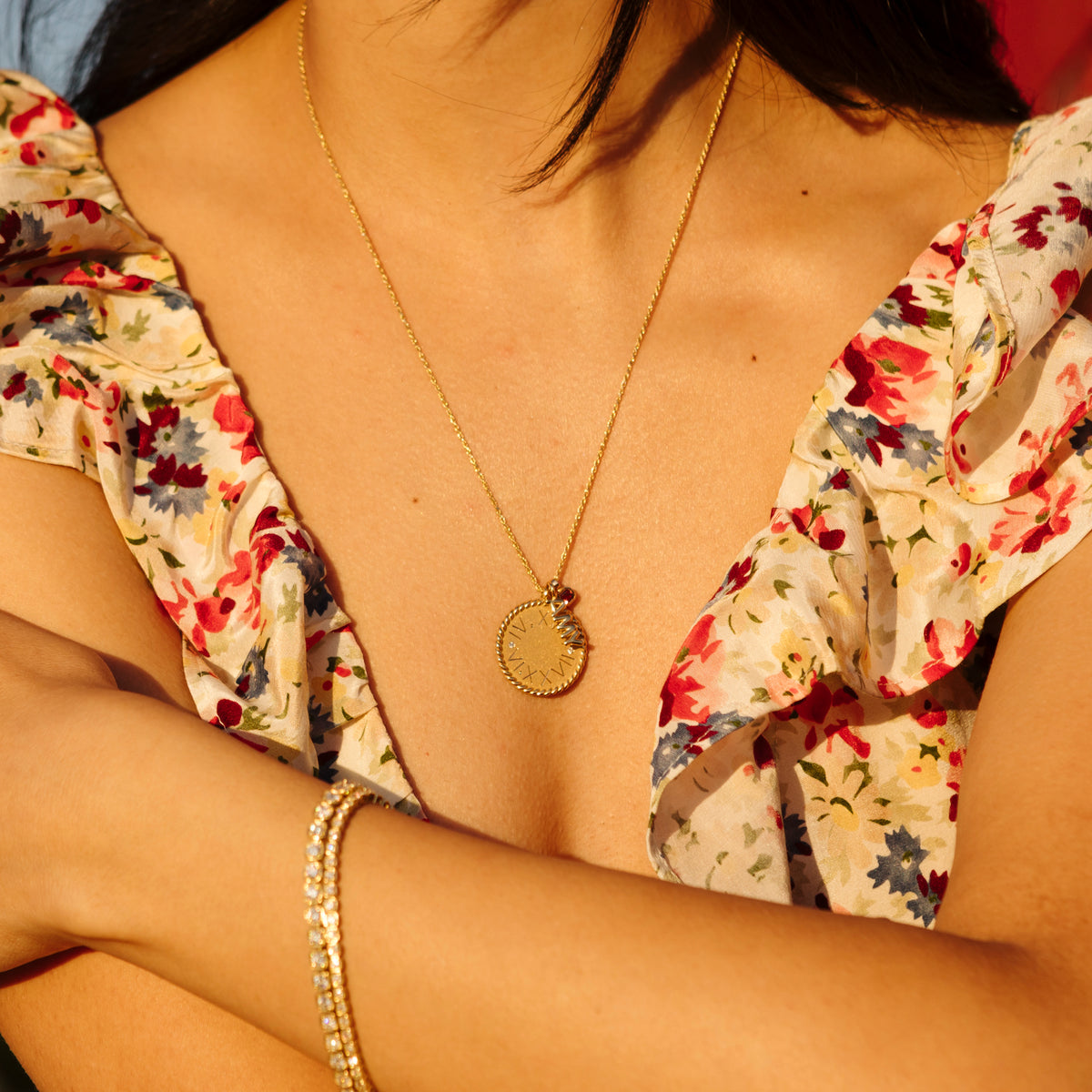 model wearing Imperial Disc Pendant, layered with 2 smaller charms