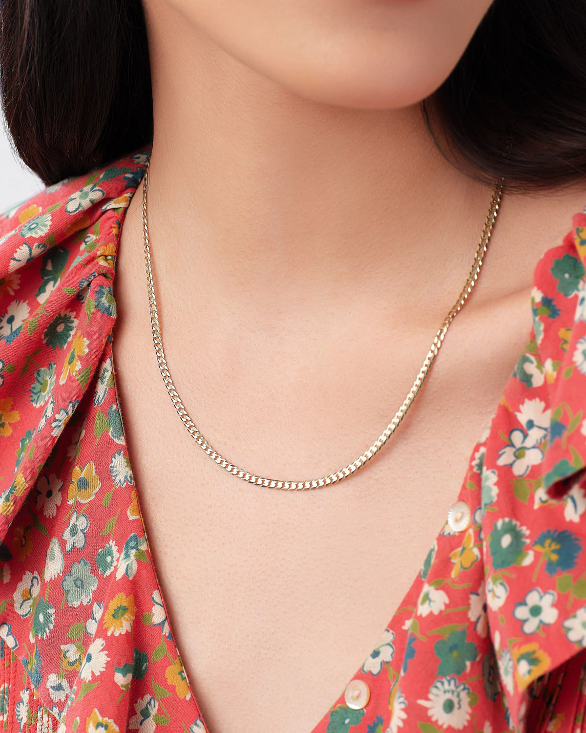 3mm Faceted Cuban Chain worn alone with a red floral blouse.