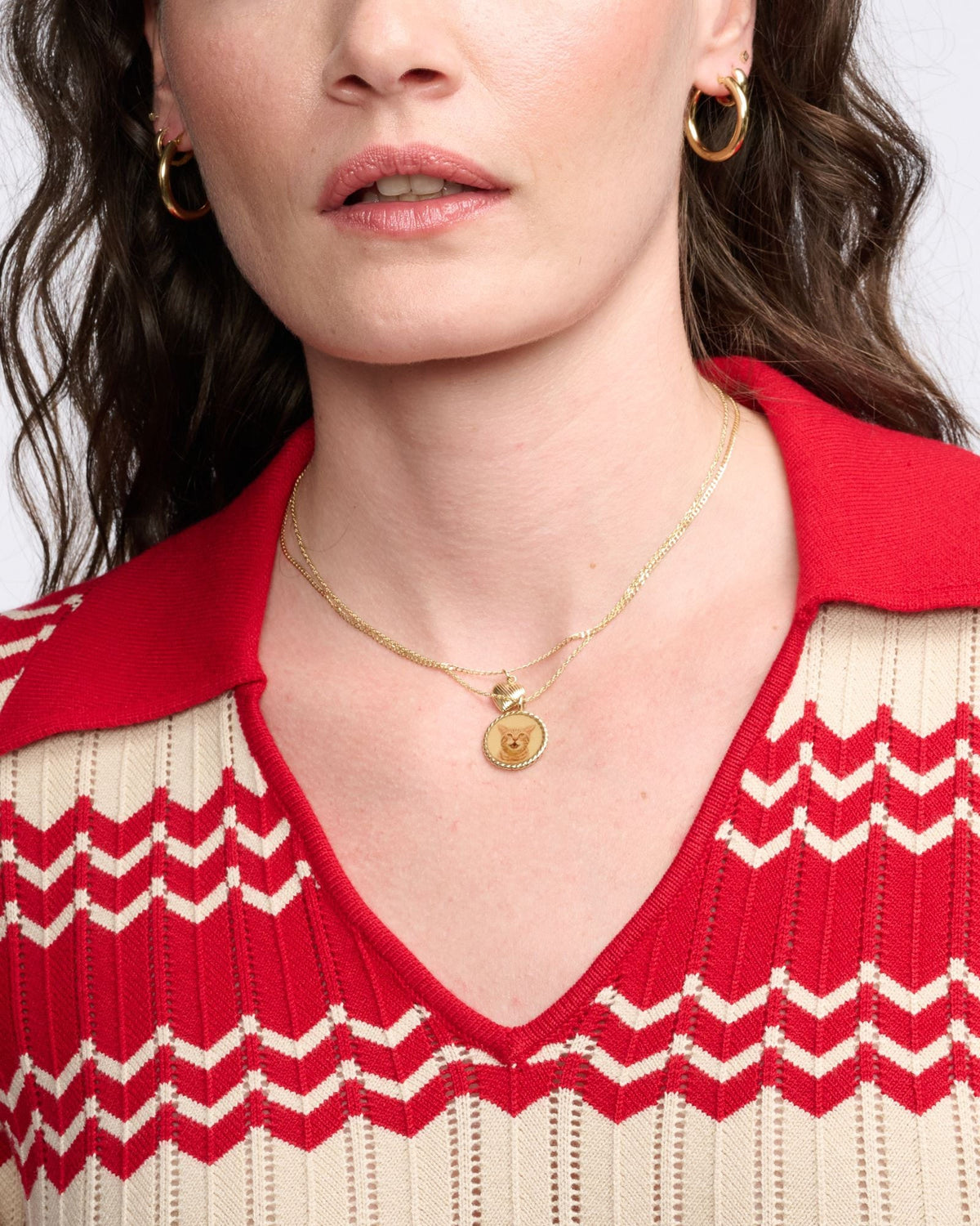 Junior Helium Hoops on both ears of a model with dark waves in a red and cream striped collar sweater.