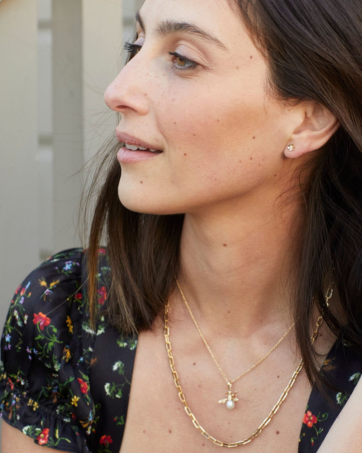 In Bloom Birthstone Stud in profile, hand in the hair, with a floral dress.