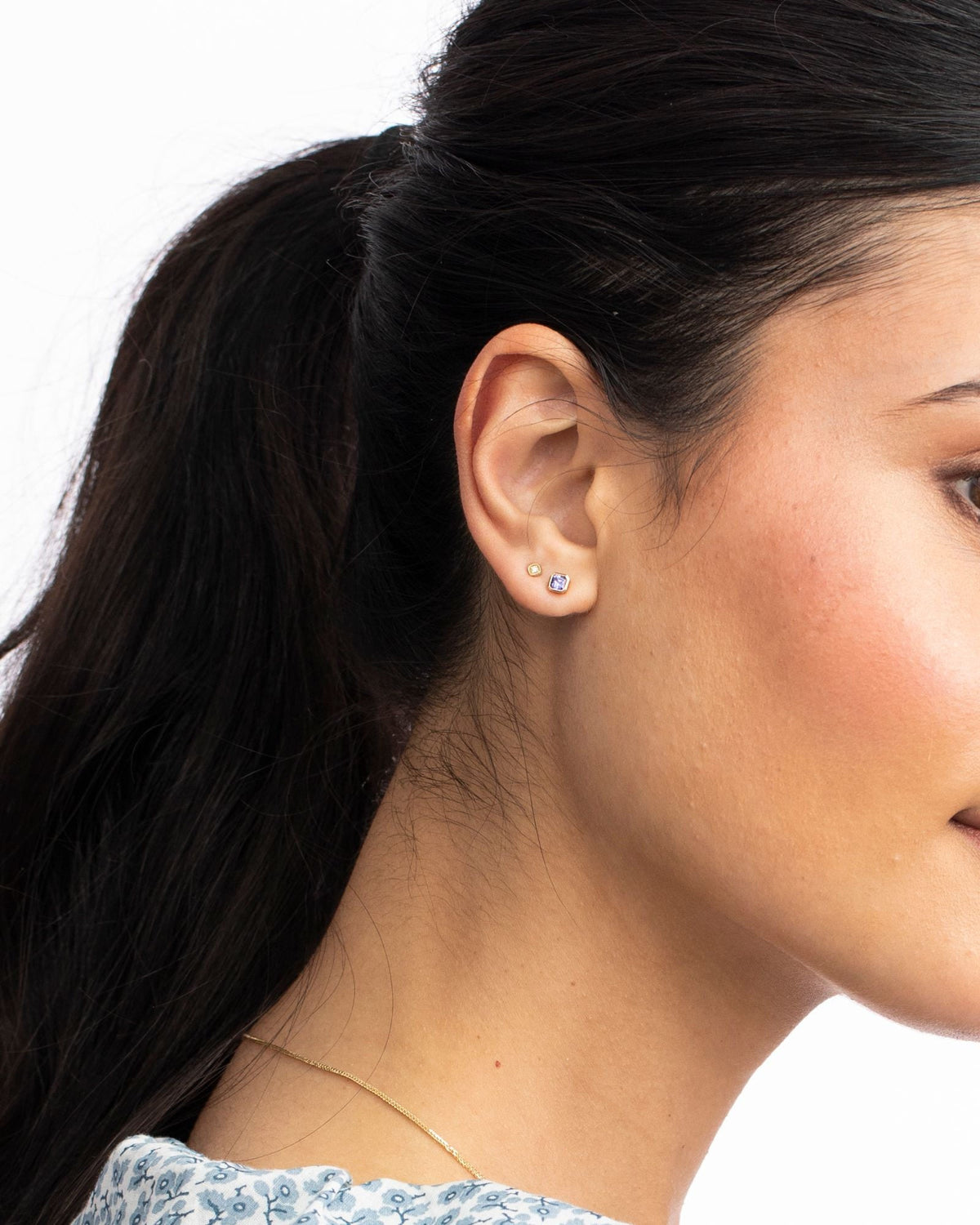 Close-up of a Petite Iris Asscher Stud on the ear, hair in a ponytail.