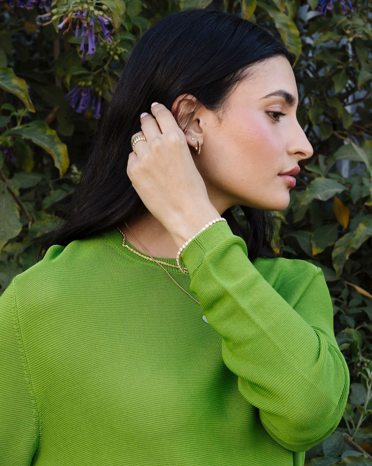 Ridged Knife Edge Helium Hoop in profile, hand at the ear, green sweater.