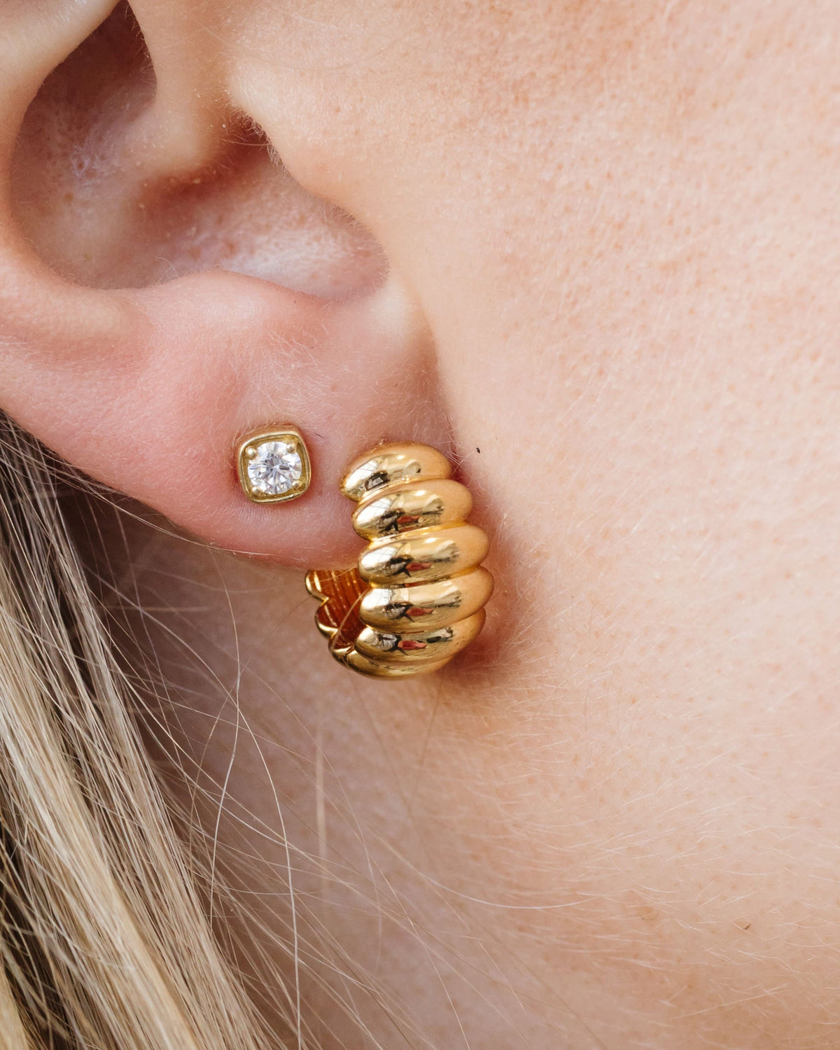 Lady Finger Helium Hoop on the ear with a square diamond stud.