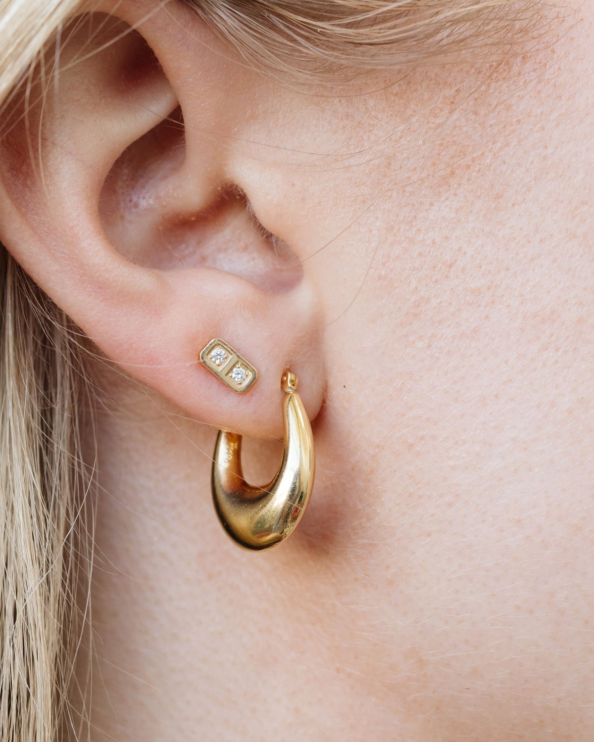 Junior Helium Teardrop Hoop on the ear with a bar stud.