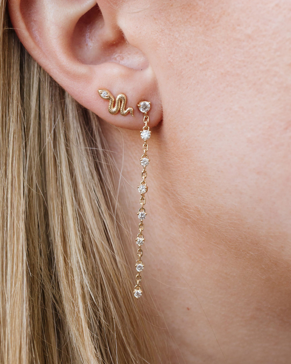 Grande Diamond Cascade Earring on the ear with a snake stud.