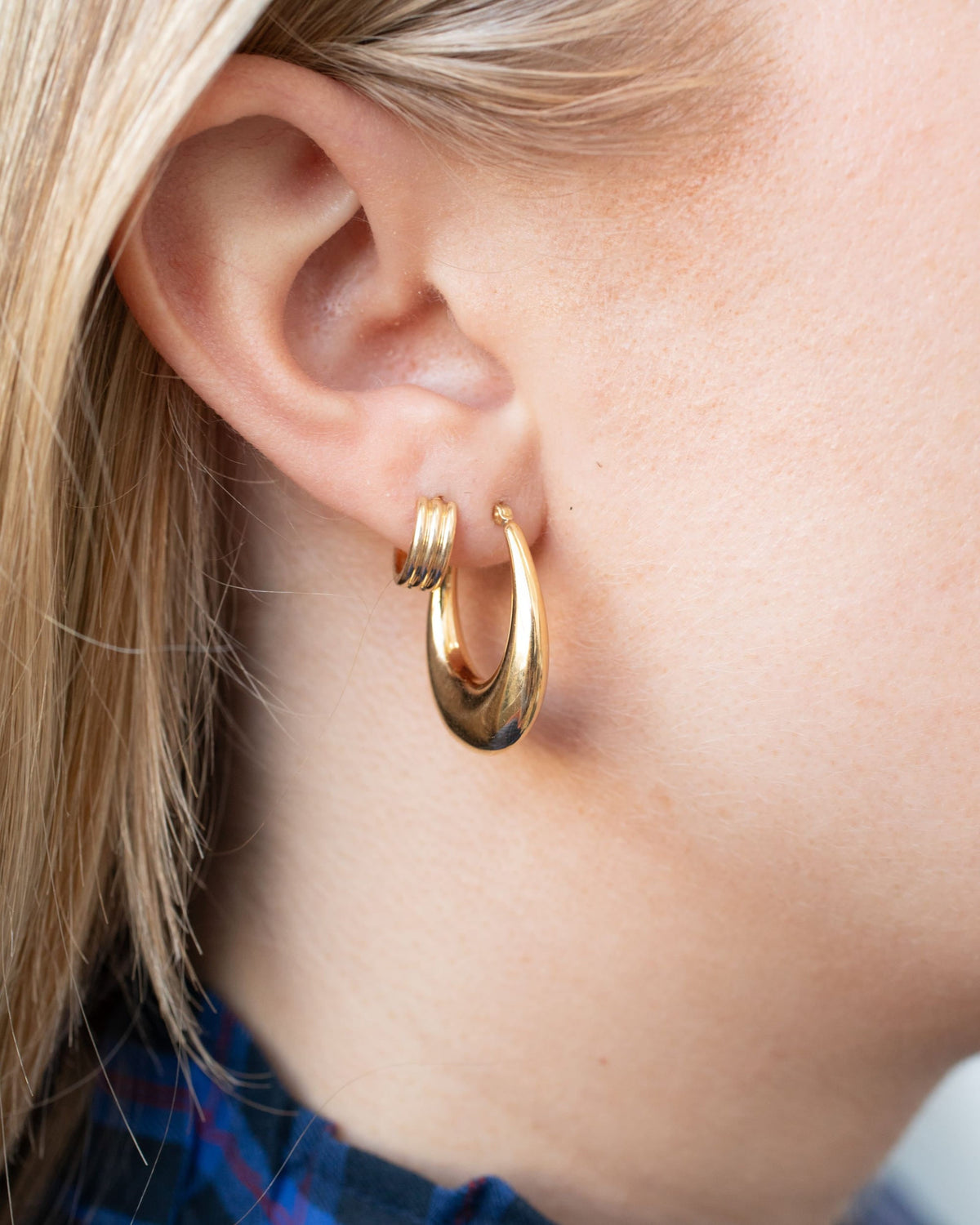 Mini Triptych Hoop on the ear with a plaid collar.