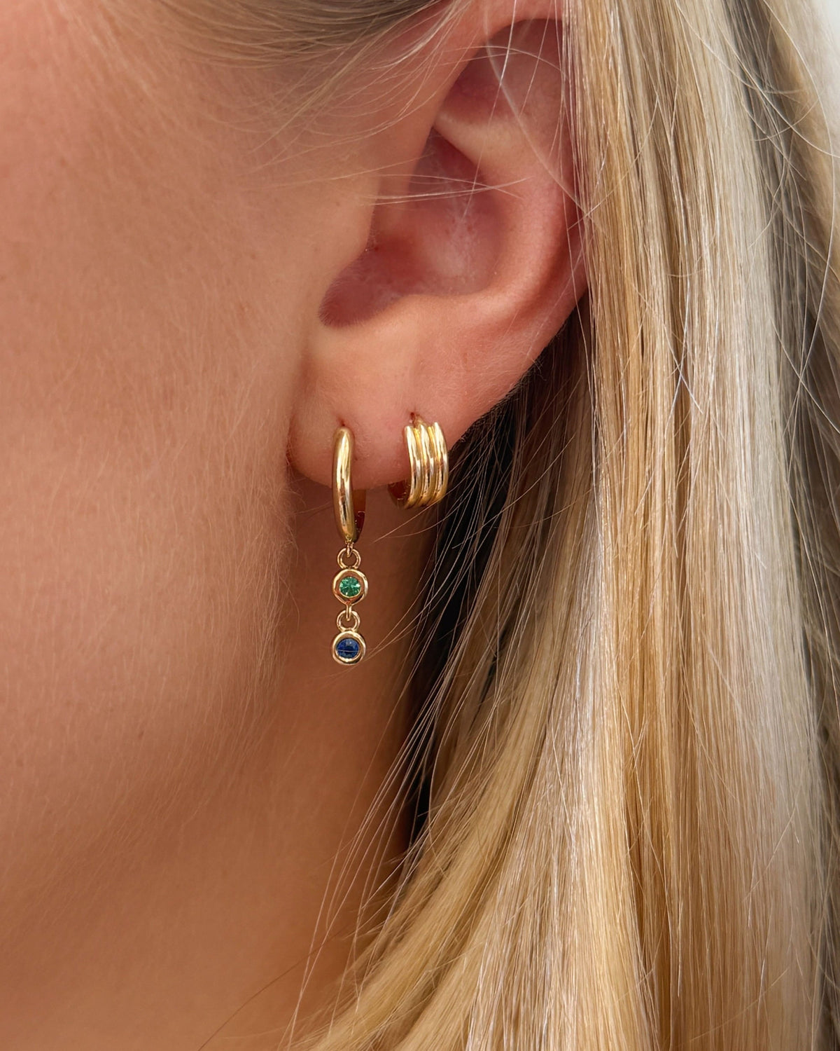 Mini Triptych Hoop on the ear beside a birthstone drop.