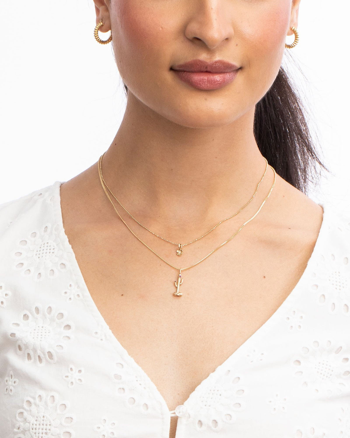 In Bloom Birthstone Charm worn with a white eyelet top.