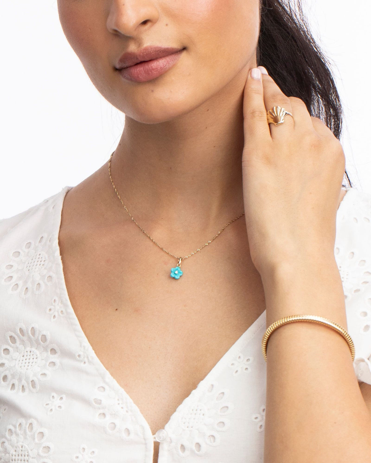 Diamond Blossom Turquoise Charm worn with a white eyelet blouse.