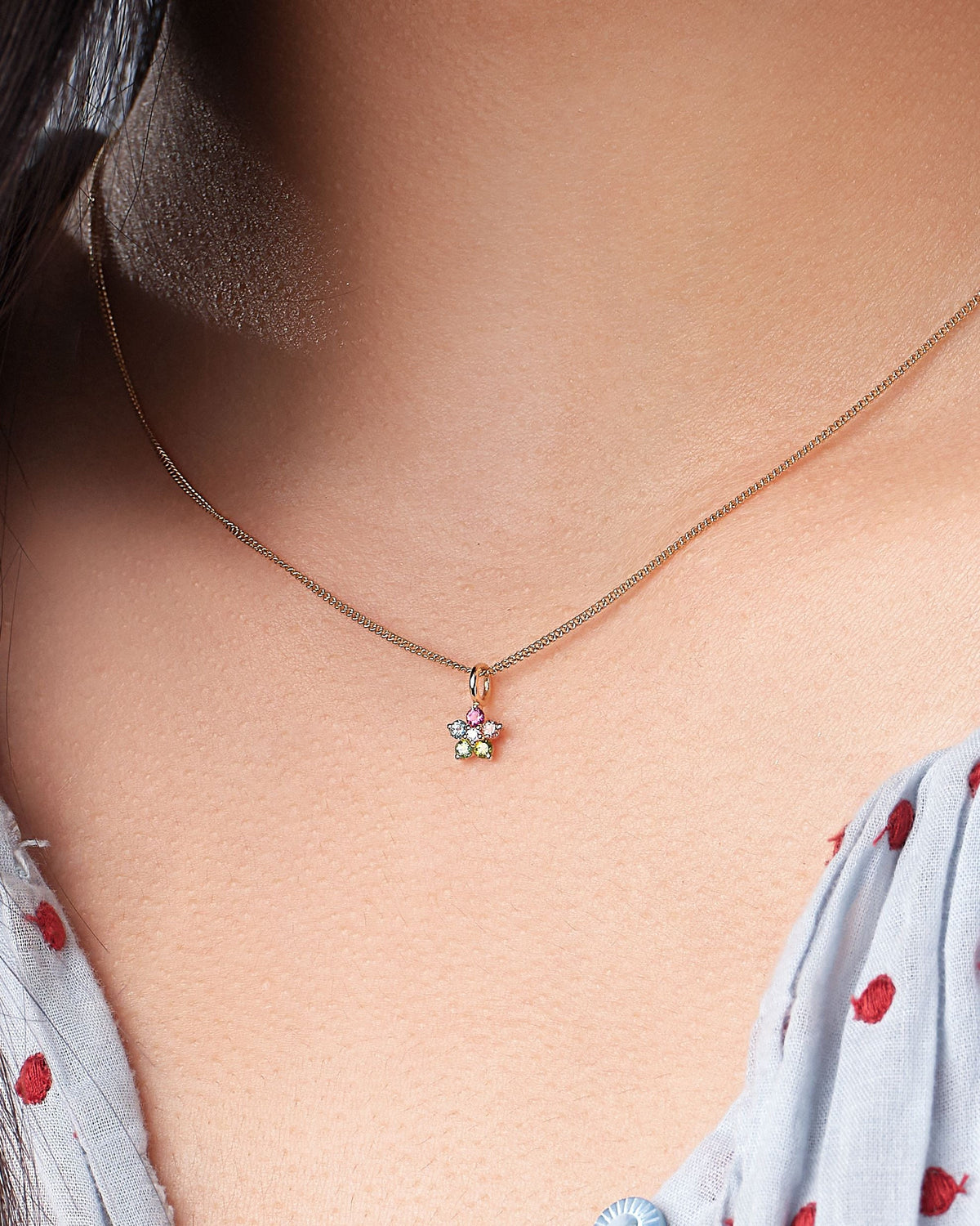Tourmaline and Diamond Aurora Charm worn with a red dot blouse.