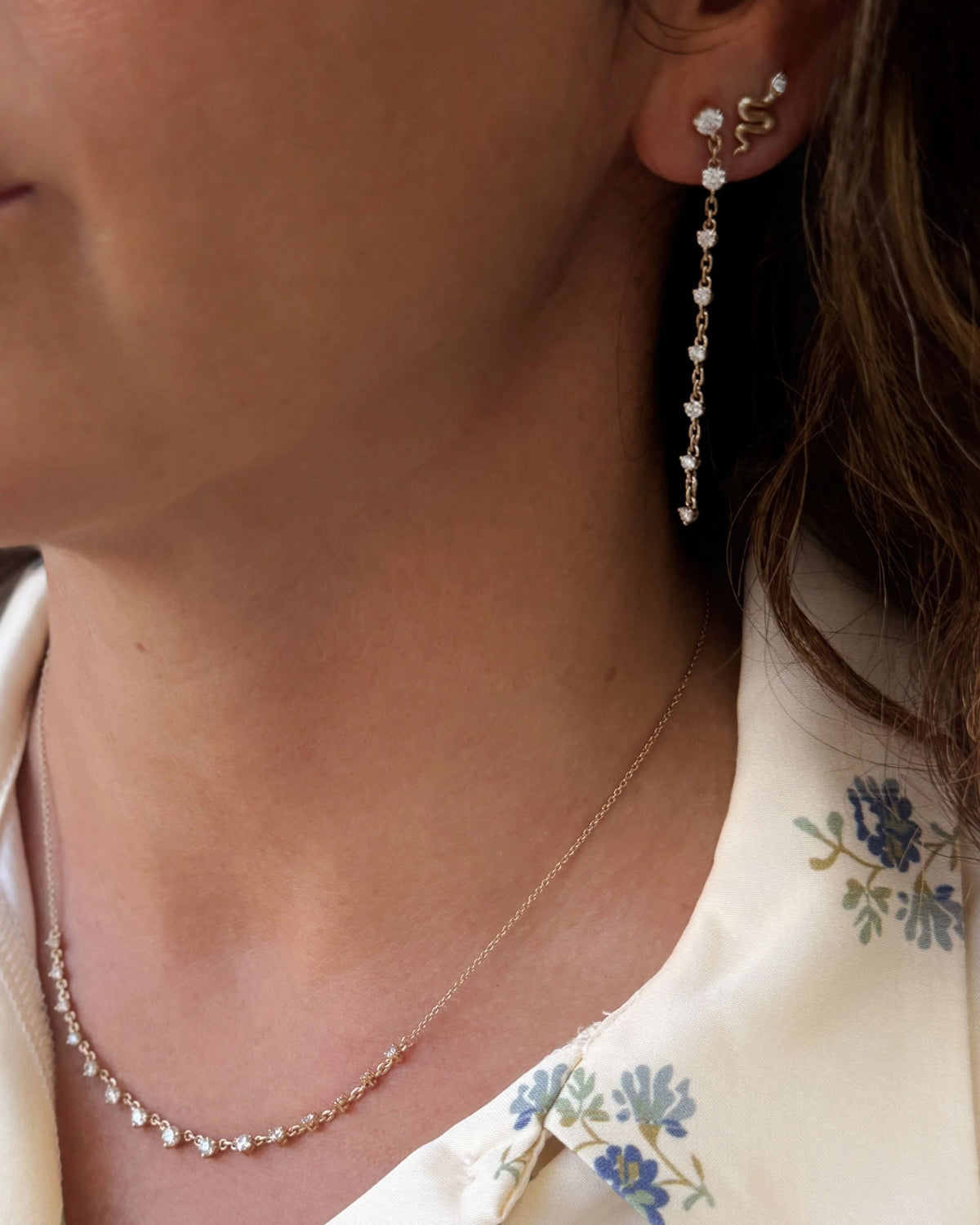 Model wearing the Grande Diamond Cascade Necklace with a floral collar and a diamond drop earring.