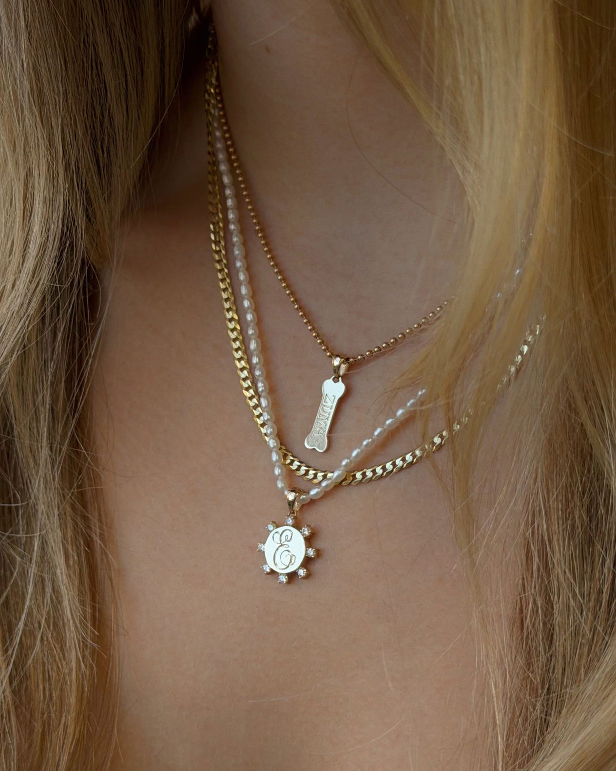 Petite Pearl Beaded Necklace in a layered stack, worn with long blonde hair.